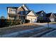 Attractive two-story home with stone facade, attached two-car garage, and landscaping at 7402 Gossamer St, Union City, GA 30291