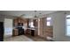 Functional kitchen with wooden cabinets, black appliances, tile backsplash and ample counter space at 7402 Gossamer St, Union City, GA 30291
