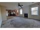 Open concept living space featuring a fireplace, a ceiling fan, and view to the kitchen at 7402 Gossamer St, Union City, GA 30291