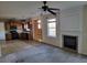 Open concept living room and kitchen with a fireplace and wood cabinets at 7402 Gossamer St, Union City, GA 30291