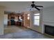Cozy living room view with fireplace, ceiling fan, and connection to the kitchen area at 7402 Gossamer St, Union City, GA 30291