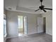 Spacious primary bedroom featuring a ceiling fan, an ensuite bath, and ample natural light at 7402 Gossamer St, Union City, GA 30291
