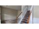 Staircase with wood railing and carpeted steps leading to upper level; room needs some TLC at 7402 Gossamer St, Union City, GA 30291