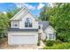 Charming two-story home with well-maintained landscaping and inviting curb appeal at 113 Weatherstone Dr, Woodstock, GA 30188