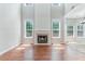 Bright, airy living room featuring hardwood floors, a fireplace and large windows at 113 Weatherstone Dr, Woodstock, GA 30188