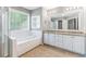 Large bathroom with dual vanity sinks, soaking tub, and walk-in shower at 113 Weatherstone Dr, Woodstock, GA 30188