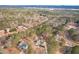 A beautiful aerial view of the home, pool, and surrounding wooded area with a lake in the distance at 320 Red Fox Dr, Canton, GA 30114