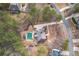 Stunning aerial view of a home with a private pool nestled among mature trees in a serene neighborhood at 320 Red Fox Dr, Canton, GA 30114