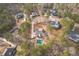 Bird's-eye view showcases a home with a private pool surrounded by other lovely homes and mature trees at 320 Red Fox Dr, Canton, GA 30114
