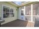 A view of the home's back porch area, featuring a door to the screened-in area and grill at 320 Red Fox Dr, Canton, GA 30114