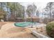 Backyard pool area with green pool cover, gazebo and shed, surrounded by trees and a grassy lawn at 320 Red Fox Dr, Canton, GA 30114
