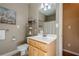 Bathroom with tile flooring, single sink vanity, commode, and artwork at 320 Red Fox Dr, Canton, GA 30114