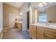 Bright bathroom boasts double vanity, wood cabinets, tile floor and separate entry to toilet and shower at 320 Red Fox Dr, Canton, GA 30114