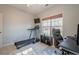 Bedroom with a treadmill, desk with computer, television and natural light from window at 320 Red Fox Dr, Canton, GA 30114