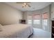 Bright bedroom with neutral tones, carpet flooring, ceiling fan, and natural light from three windows at 320 Red Fox Dr, Canton, GA 30114