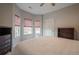 Bedroom with carpet flooring, natural light from windows, and a TV stand with dresser at 320 Red Fox Dr, Canton, GA 30114