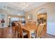 Bright dining area with hardwood floors and a chandelier, open to the living room and kitchen at 320 Red Fox Dr, Canton, GA 30114
