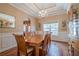 Elegant dining room with a chandelier, hardwood floors, and wainscoting, ideal for Gathering gatherings at 320 Red Fox Dr, Canton, GA 30114