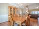 Bright dining room featuring hardwood floors, a large table, and open access to the living area at 320 Red Fox Dr, Canton, GA 30114