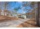 A charming exterior view of a single-Gathering home with a large front yard and long driveway at 320 Red Fox Dr, Canton, GA 30114