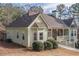 A rear view of a charming single-Gathering home with a large covered porch and an attached garage at 320 Red Fox Dr, Canton, GA 30114