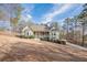 A front view of a charming single-Gathering home with a large front yard and long driveway at 320 Red Fox Dr, Canton, GA 30114
