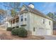 Charming light-green home with stone accents, a two-car garage, and a covered porch at 320 Red Fox Dr, Canton, GA 30114