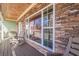 Inviting front porch showcasing stone accents, rocking chairs, and ample natural light reflection through the window at 320 Red Fox Dr, Canton, GA 30114