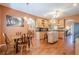 Spacious kitchen and dining area featuring wooden cabinets, hardwood floors, an island, and modern appliances at 320 Red Fox Dr, Canton, GA 30114