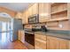 Updated kitchen with stainless steel appliances, wooden cabinets, hardwood floors, and lots of counter space at 320 Red Fox Dr, Canton, GA 30114