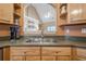 Close up of kitchen sink with a view through the upper cabinets to the fireplace at 320 Red Fox Dr, Canton, GA 30114