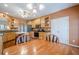 Eat-in kitchen featuring hardwood floors, light wood cabinetry, a center island, and stainless steel appliances at 320 Red Fox Dr, Canton, GA 30114