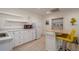 Kitchenette featuring white cabinets, butcher block island, stainless sink, microwave, and mini fridge at 320 Red Fox Dr, Canton, GA 30114