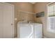 Laundry room with washer, dryer, shelving and natural light from window at 320 Red Fox Dr, Canton, GA 30114