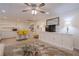 Basement living room with kitchenette, white cabinets, television, ceiling fan, rug, and furniture at 320 Red Fox Dr, Canton, GA 30114