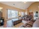 Open-concept living room featuring large windows, hardwood floors, and comfortable seating arrangements at 320 Red Fox Dr, Canton, GA 30114