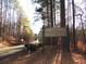 Welcome to Field's Landing Park sign at entrance with greenery, trees, and road at 320 Red Fox Dr, Canton, GA 30114