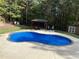Backyard features a sparkling swimming pool with a tanning ledge and a gazebo with outdoor seating at 320 Red Fox Dr, Canton, GA 30114
