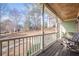 An inviting covered front porch with rocking chairs and a beautiful view of the front yard at 320 Red Fox Dr, Canton, GA 30114