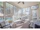 Relaxing screened porch featuring comfortable seating, offering a peaceful view of the backyard and pool at 320 Red Fox Dr, Canton, GA 30114