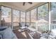 Screened-in porch with comfortable seating and view of the beautiful backyard and swimming pool at 320 Red Fox Dr, Canton, GA 30114