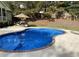 Refreshing swimming pool with clear water, a clean surrounding patio, and lush green trees at 320 Red Fox Dr, Canton, GA 30114