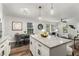 Open-concept kitchen with granite island, seating, and views into the living and dining areas at 338 Lincoln Sw St, Atlanta, GA 30315