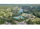 Expansive aerial view of the community featuring lush greenery, a serene lake, and well-maintained tennis courts at 3690 Millwater Xing, Dacula, GA 30019