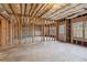 Unfinished basement features concrete floors and exposed ceiling at 3690 Millwater Xing, Dacula, GA 30019