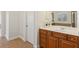 Bathroom boasts a wooden vanity with drawers and a white countertop and sink at 3690 Millwater Xing, Dacula, GA 30019