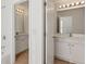 Updated bathroom featuring double vanities, a large mirror, and modern lighting at 3690 Millwater Xing, Dacula, GA 30019