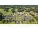 Aerial view of the community center and parking, surrounded by trees, golf course, and well-kept lawns at 3690 Millwater Xing, Dacula, GA 30019
