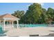 Outdoor community pool featuring covered lounge area, chairs, and a lifeguard for the Gathering at 3690 Millwater Xing, Dacula, GA 30019