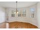 Bright dining area with hardwood floors, large windows with shutters, and an elegant chandelier at 3690 Millwater Xing, Dacula, GA 30019